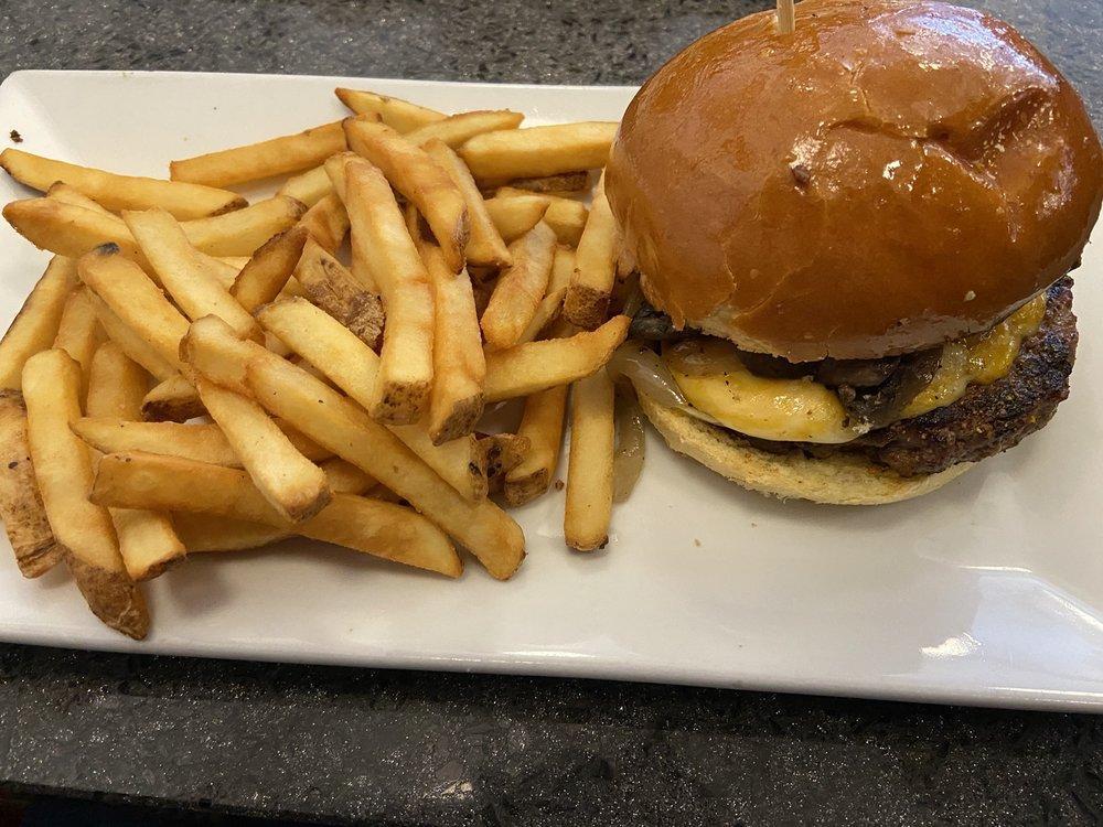 Cowboy Burger · Spicy blackened burger, grilled mushrooms, onions, bacon and Jack cheese. Certified USDA Angus beef hand pressed and char broiled served on our signature brioche bun. Served with french fries or Side Salad.