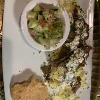 Gyro Plate · Juicy pieces of mixed lamb and beef gyro strips accompanied with tzatziki dip, served with p...