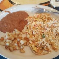 Migas · Eggs scrambled with homemade corn tortilla strips, tomato, onion, jalapeno and cilantro, top...