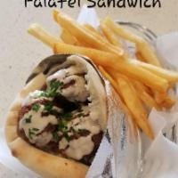 Falafel Sandwich · A pita bread stuffed with our crispy and fluffy falafel balls, a mash of hummus or tahini, I...