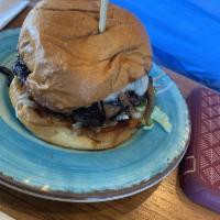 Magic Mushroom Burger · Lettuce, tomato, onion, herb mayo, garlic butter mushrooms, sherry butter onions, and swiss.
