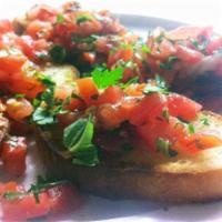 Bruschetta · Toasted rounds of our freshly baked bread topped with chopped tomato, garlic and basil.
