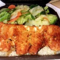 Salmon Teriyaki Bowl · Pan-seared salmon, served with our signature sauce on a bed
of rice.