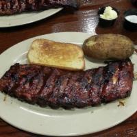 Baby Back Ribs · Served with BBQ beans, coleslaw, and garlic bread.