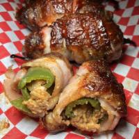 Smoked Piggy Poppers · Four fresh jalapeno peppers, stuffed with pulled pork and smoked Gouda wrapped in bacon and ...