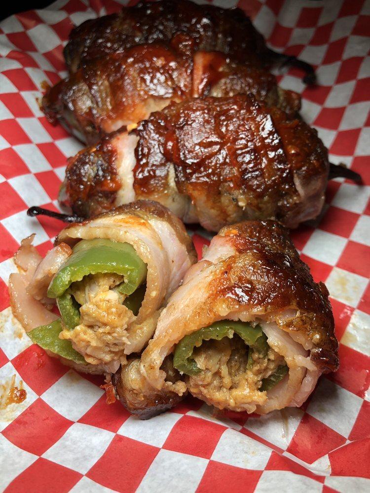 Smoked Piggy Poppers · Four fresh jalapeno peppers, stuffed with pulled pork and smoked Gouda wrapped in bacon and smoked to perfection. Served with tangy BBQ ranch dip.