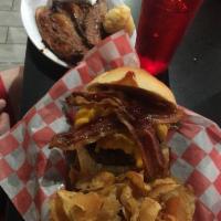 The Boss Hog Burger · Layered with mac and cheese, sweet BBQ pulled pork, melted cheddar, applewood smoked bacon a...