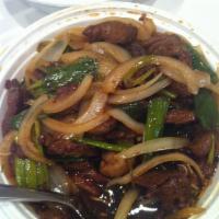 Mongolian Beef · Beef sautéed with white onion,green onion and mushrooms in sweet brown sauce. Served with cr...