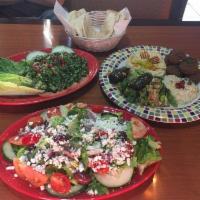 Greek Salad · Romaine Lettuce, Kalamata olives, grape tomatoes, cucumber, Feta Cheese, onion and dressing ...