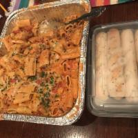 Rigatoni with Bolognese Sauce Family Style Dinner · Al dente rigatoni with traditional Bolognese meat sauce of beef, Italian sausage, pear tomat...