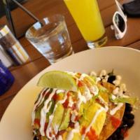 Huevos Rancheros · Black beans, crispy corn tortillas, green chili pork, cotija, 2 eggs, Mexican salsa, pico de...