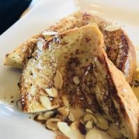 French Toast · Three slices of battered brioche bread served with graham cracker syrup and honey butter. Se...