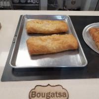 Bougatsa · Phyllo dough, custard cream, fine sugar, and cinnamon.