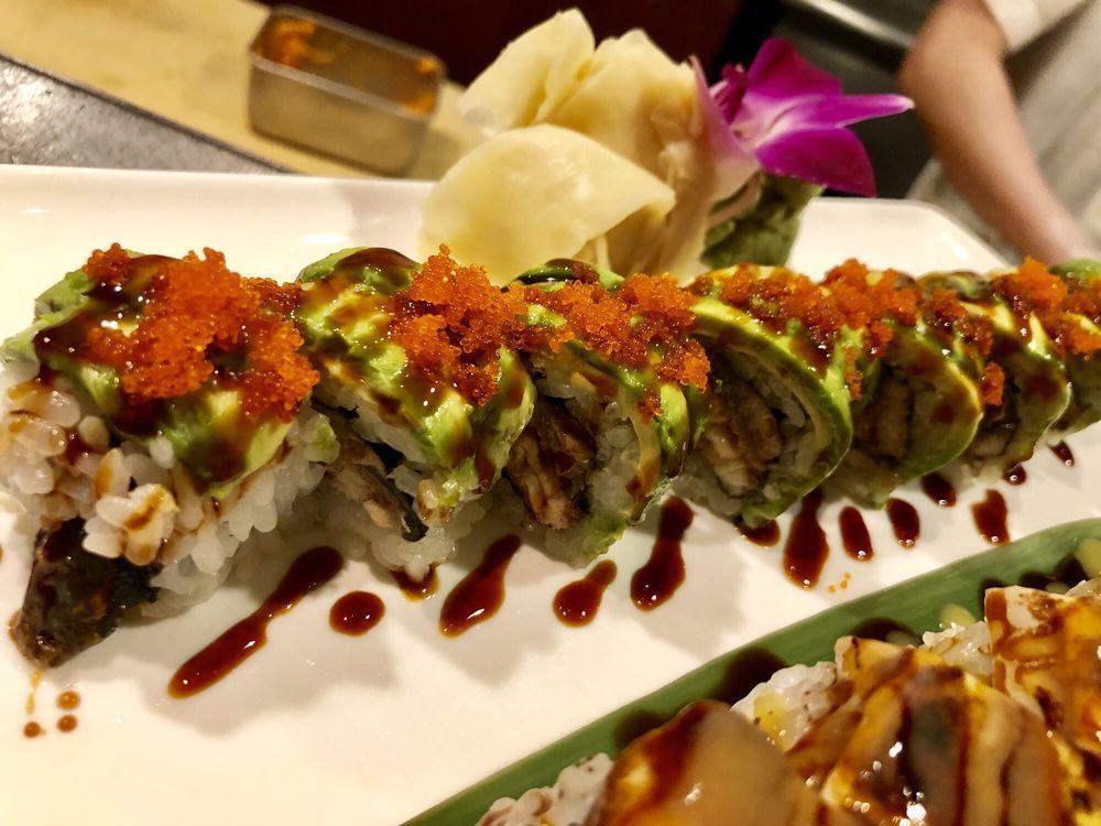 Dragon Roll · Baked eel and cucumber wrapped inside out, avocado and tobiko on top with eel sauce.