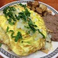 Chilaquiles · Tortilla chips topped with chicken or egg, covered with green, ranchero or red sauce, topped...