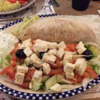 Greek Salad · Romaine lettuce, tomatoes, cucumbers, olives, red onions, feta cheese, anchovies and pita br...