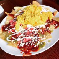 Chilaquiles · Tortilla chips, cream, queso fresco, beans, avocado, 2 eggs and your choice of red or verde ...