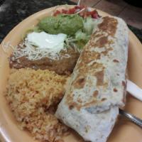 Carne Asada Special · 2 steaks on the grill. Includes rice, beans, guacamole, sour cream, lettuce and tortillas.