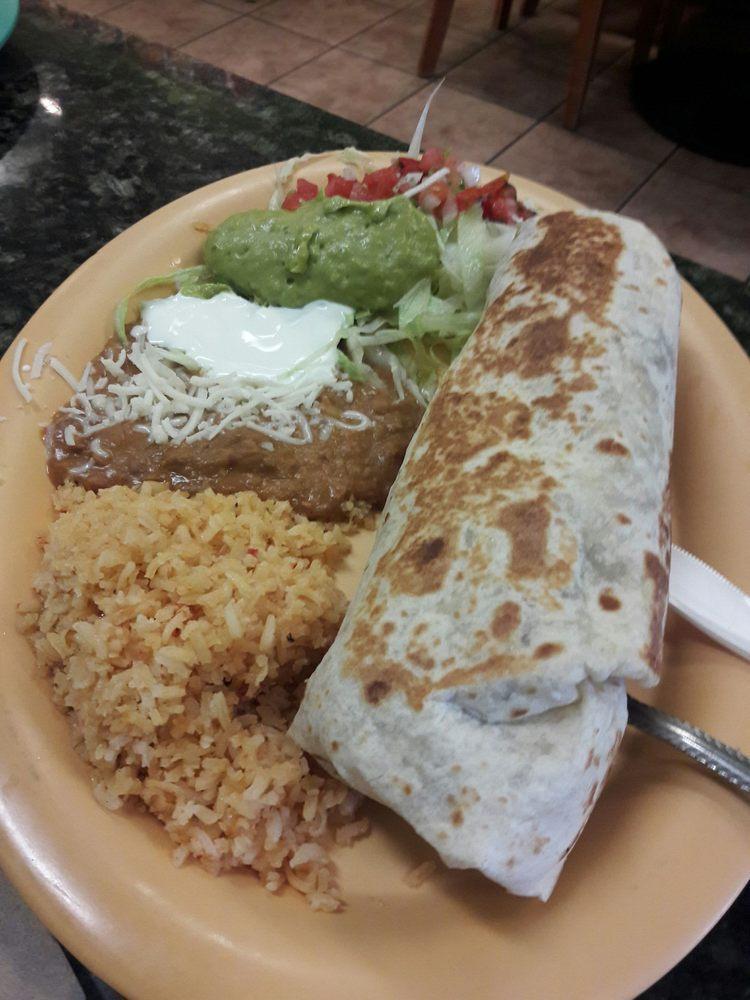 Carne Asada Special · 2 steaks on the grill. Includes rice, beans, guacamole, sour cream, lettuce and tortillas.