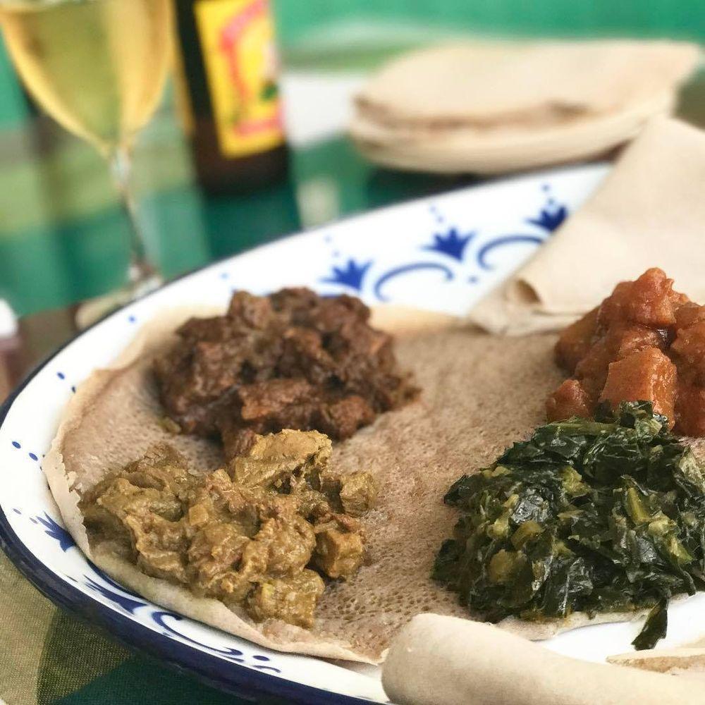 Meat Combo · Four meat dishes. Served with two injera and three vegetarian side dishes.