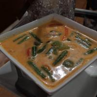 Panang Curry · Bell pepper, Green bean and Fresh Basil in Panang 
curry sauce topped with Kaffir lime leaves

