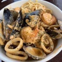 Seafood Fiesta · Shrimp, scallops, clams, mussels, calamari, crab meat and linguini simmered in your choice o...