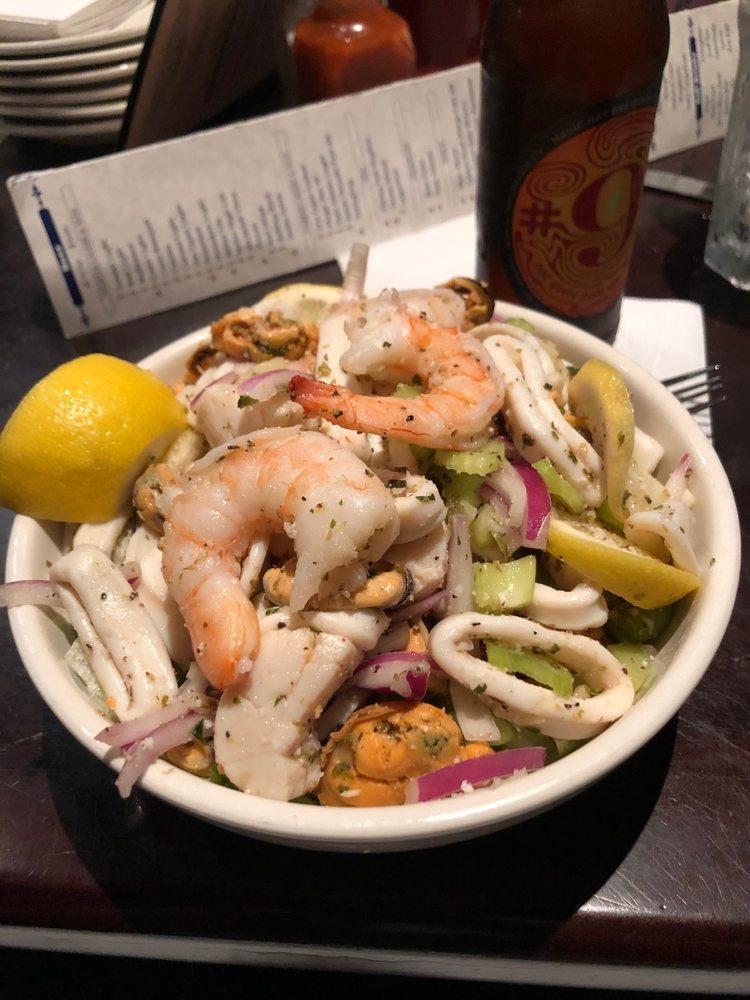 Seafood Salad · Scallops, shrimp, mussels, calamari, sliced celery and red onions marinated in olive oil, lemon juice and Italian herbs. Served chilled atop iceberg lettuce