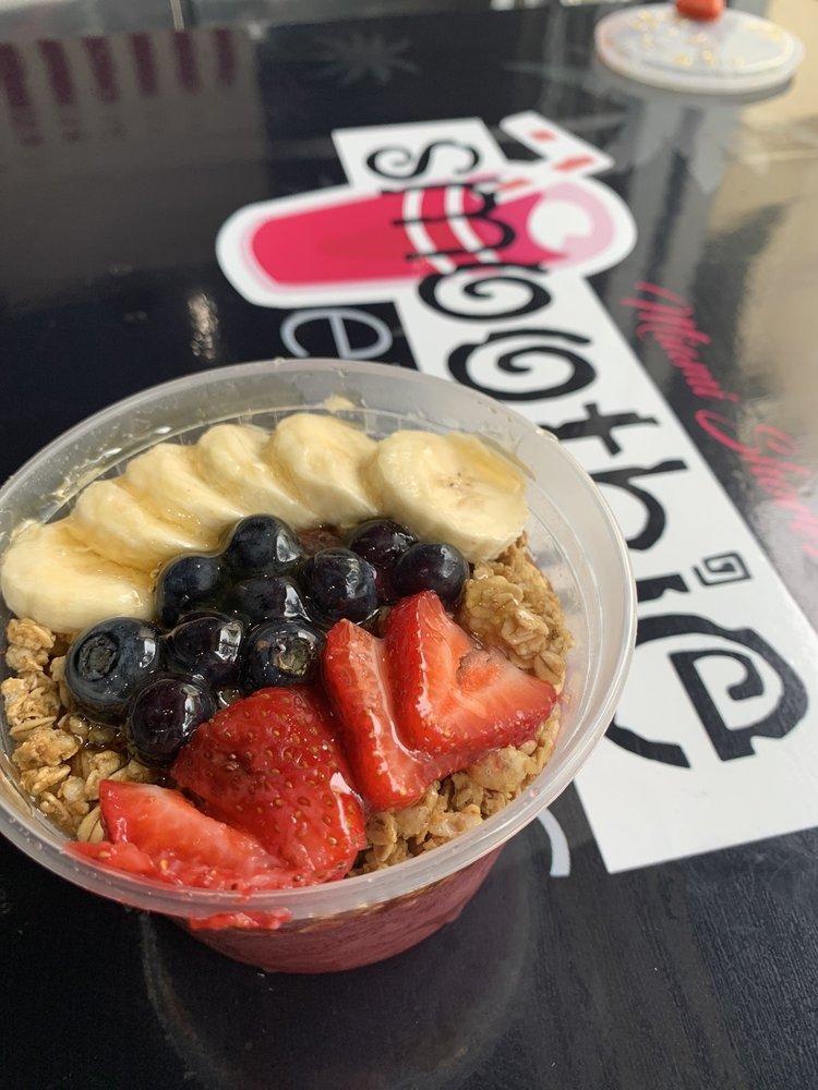 Acai Bowl · Acai fruit blend, topped with banana, granola, fresh strawberries, blueberries, agave, and chia seeds.