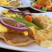 Divorced Eggs · 2 crispy corn tortillas, 2 eggs any which way, green and red salsa pinto beans, jalapenos on...