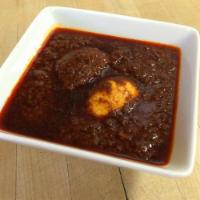 Doro Wot · A drumstick cooked to tenderness sauteed in onions paprika (berbere) sauce, served with hard...