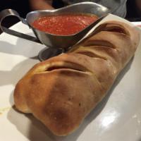 Meat Stromboli · Mozzarella, pepperoni, sausage, meatballs, ham, and bacon.