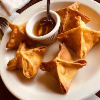 Crab Rangoon · 6 pieces. Crabmeat with cream cheese in crispy wonton wraps, served with sweet and sour sauce.