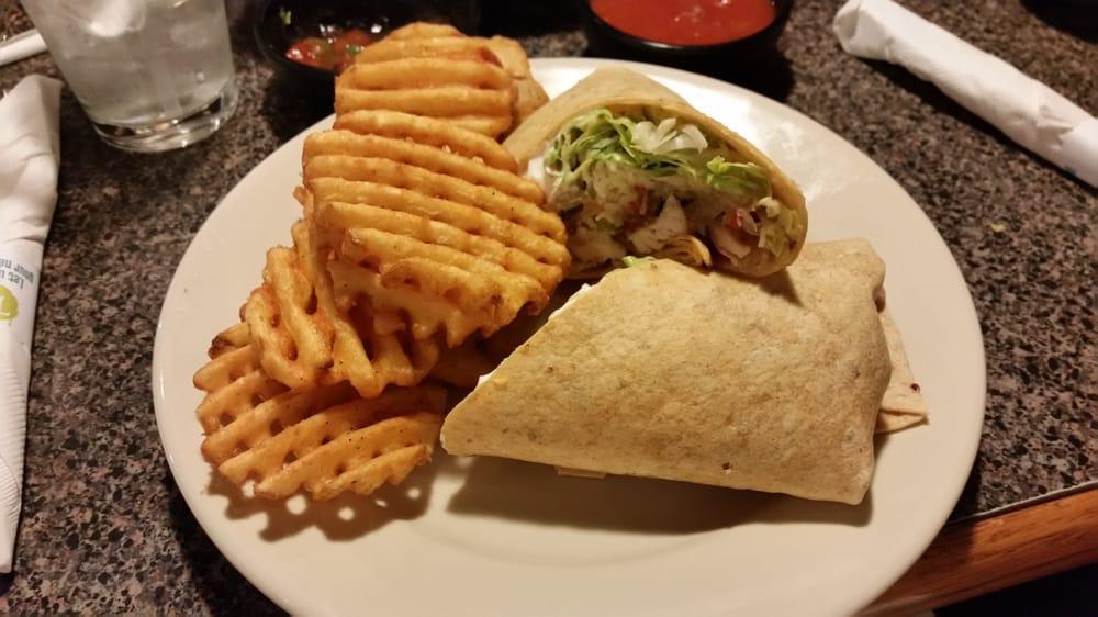 Chicken Fajita Wrap · Fajita chicken with grilled peppers and onions, pico de gallo, sour cream, lettuce and cheese in a soft chipotle tortilla.  Served with your choice of side.