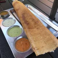 Masala Dosa · Thin rice and lentil crepe filled with spiced mashed potatoes and onions. Served with 3 vari...