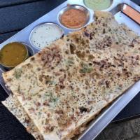 Onion Masala Dosa · Thin rice and lentil crepe filled with potatoes and onion. Served with 3 varieties of chutne...