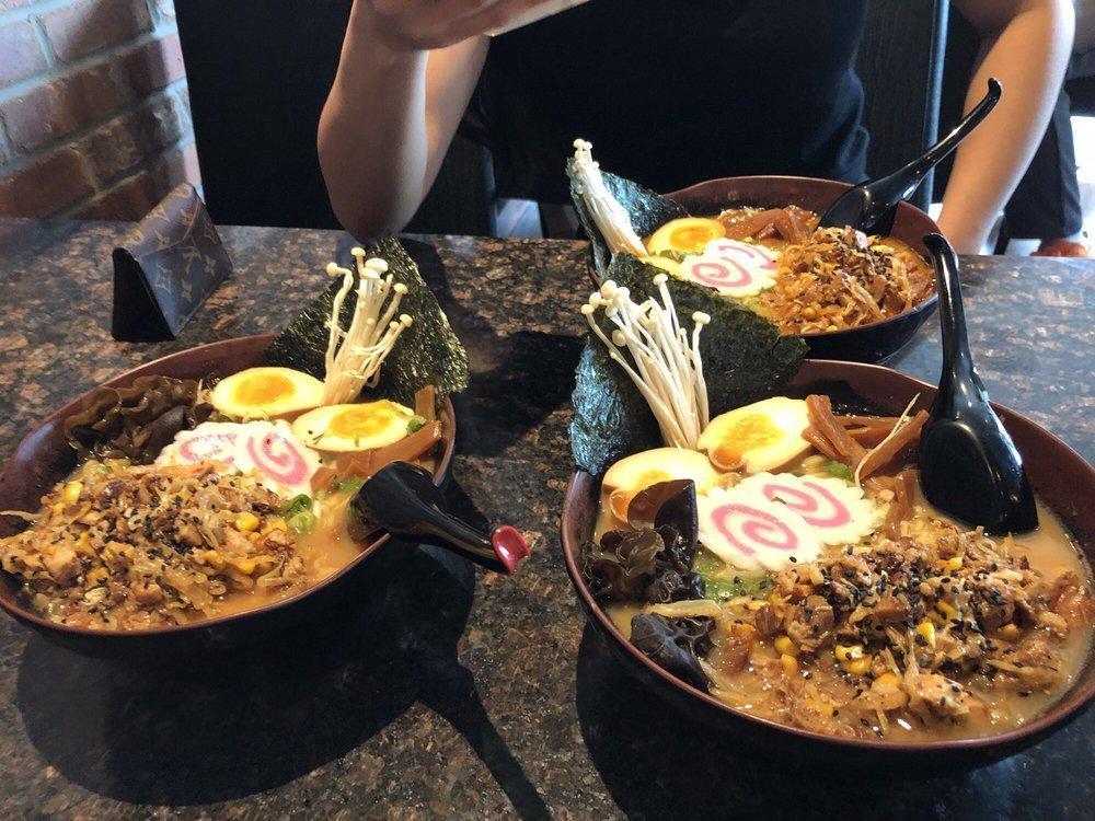 Miso Ramen Bowl · 7 Hour chicken broth, Miso Soup Base, Chopped Pork, Cabbage, Corn, Soft Boiled Egg, Scallions, Wood Ear Mushrooms, Enoki Mushrooms, Bamboo Shoots, Naruto, Nori, Bean sprout, and black sesame seeds.