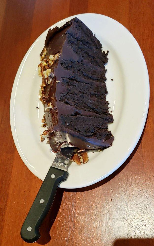 Chocolate Motherlode Cake · Six decadent layers of chocolate cake and rich fudge icing, topped with walnuts. Featured on the Food Network as one of America’s “Top 5 Most Decadent Desserts”