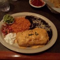 Texas Chimichanga · Ground beef and seasoned shredded chicken wrapped in a large flour tortilla and fried to a g...