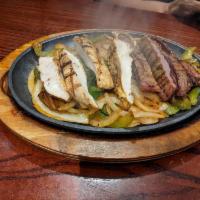 Grilled Steak Fajita · Served with green peppers, onions, and tomatoes. Accompanied by Mexican rice, black beans, 3...