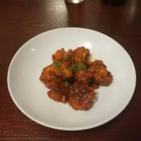 Gobi Manchurian · Fried golden cauliflower flowerets folded in a tangy tomato and garlic sauce, finished with ...