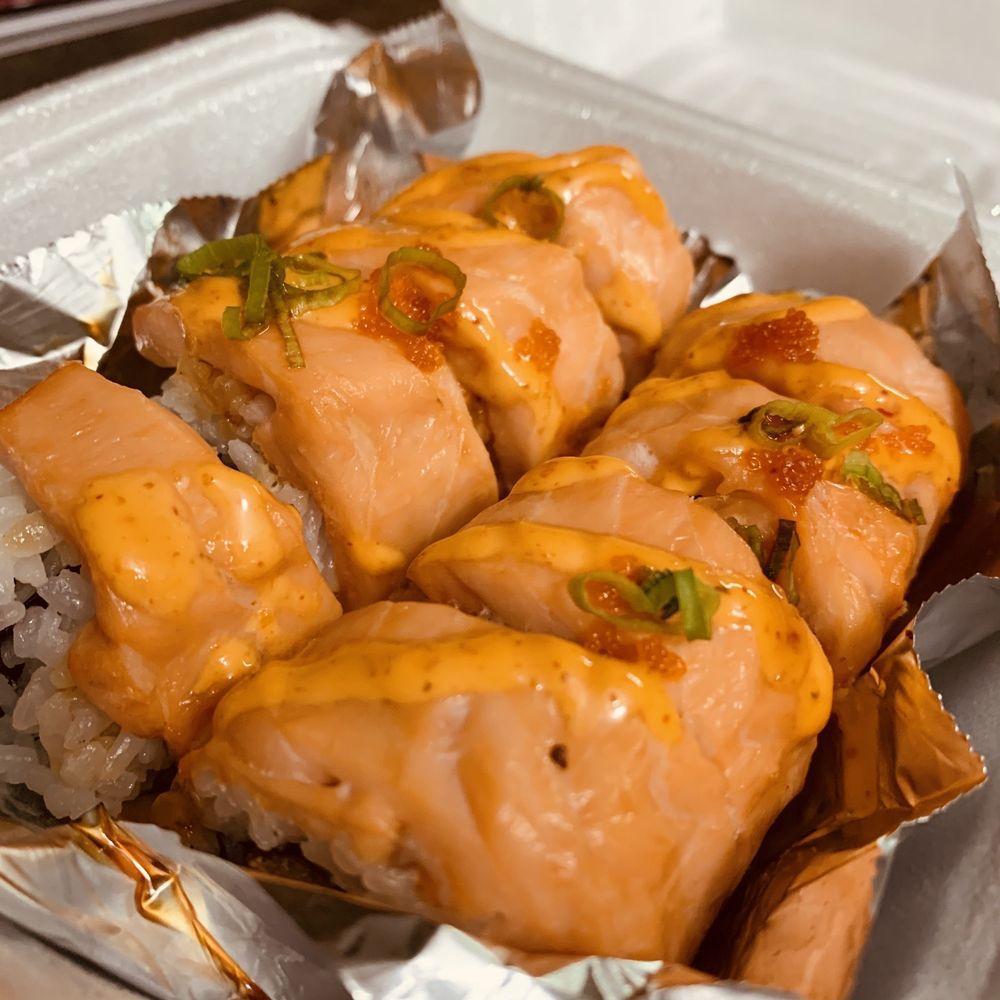 Naughty Girl Roll · Shrimp tempura, avocado, cream cheese, topped with salmon, spicy mayo, sweet sauce, masago and onions. Spicy.
