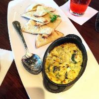 Artichoke Fondue Kettle · Baked artichoke and spinach dip, served with crostini.
