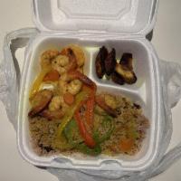 Coconut Curry Shrimp · Jumbo shrimp simmered in a coconut curry sauce. Served with rice and peas and choice of side.