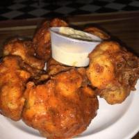 Cauliflower Wings · Cauliflowers bites tossed in IDK batter and Fried. Tossed in sauce of choosing.