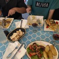 Greek Salad · Lettuce, tomato, onion, peppers, cucumbers. Kalamata olives and feta, served with pita and e...