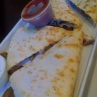 Steak Quesadilla · Mushrooms, caramelized onions and mozzarella cheese in a flour tortilla. Served with sour cr...