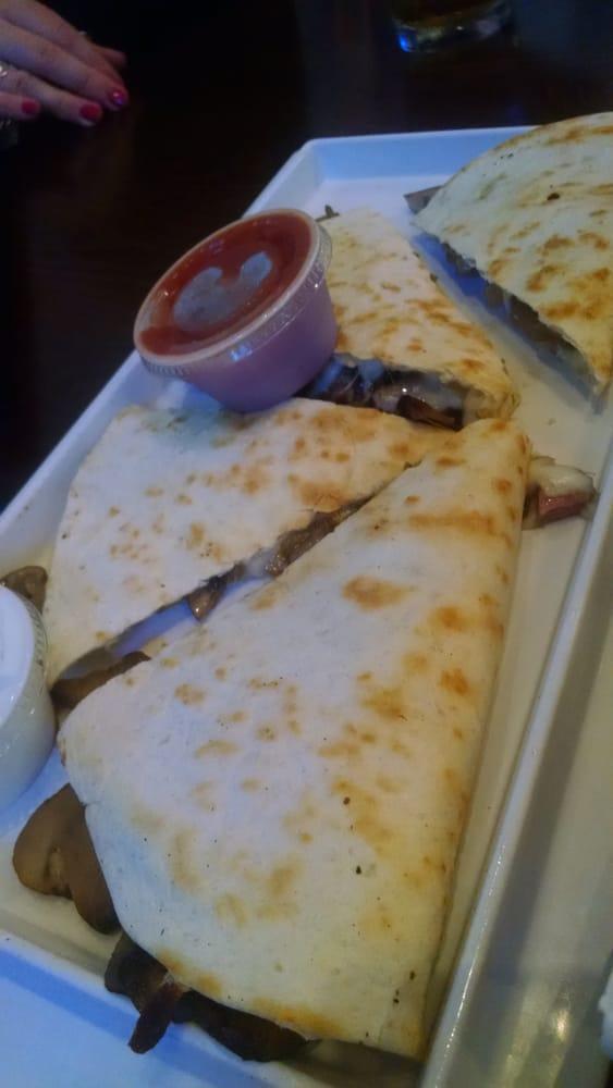 Steak Quesadilla · Mushrooms, caramelized onions and mozzarella cheese in a flour tortilla. Served with sour cream and salsa.