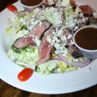 Black and Bleu Tenderloin Salad · Grilled petite beef tenderloin sliced and served over a bed of greens with sliced red onion,...