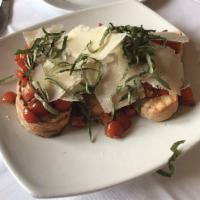 Bruschetta · Sliced cherry tomatoes and garlic over toasted ciabatta bread topped with shaved Parmigiano ...