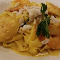 Fettuccine Zafferano · Gulf shrimp, sea scallops, lump crabmeat sauteed in a creamy saffron sauce over fettuccine.
